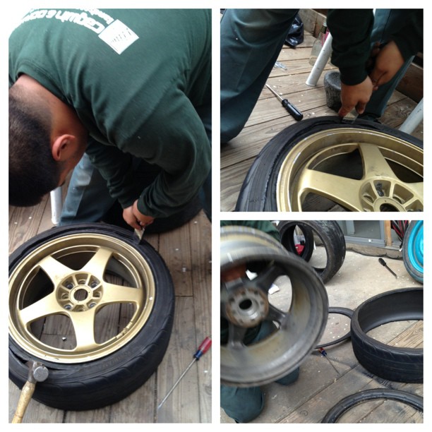 car mechanic repairing slash tires